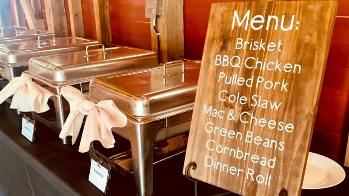 catering menu on a table with brisket, bbq chicken, pulled pork, and more