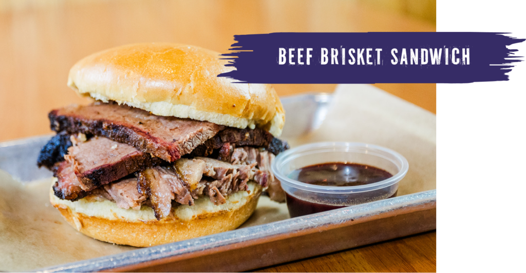 beef brisket sandwich on a tray with bbq sauce